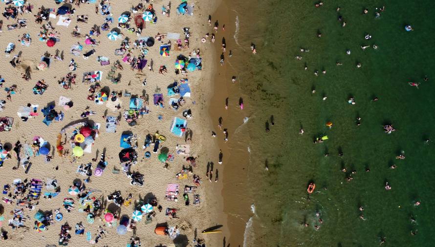 People and children enjoy the hot weather at Bournemouth Beach