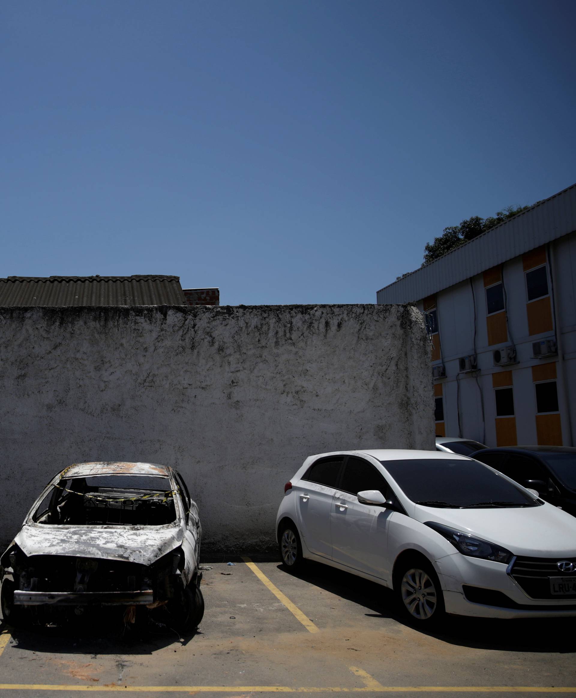 A burned car in which a body was found during searches for the Greek Ambassador for Brazil Kyriakos Amiridis, is pictured at a police station in Belford Roxo