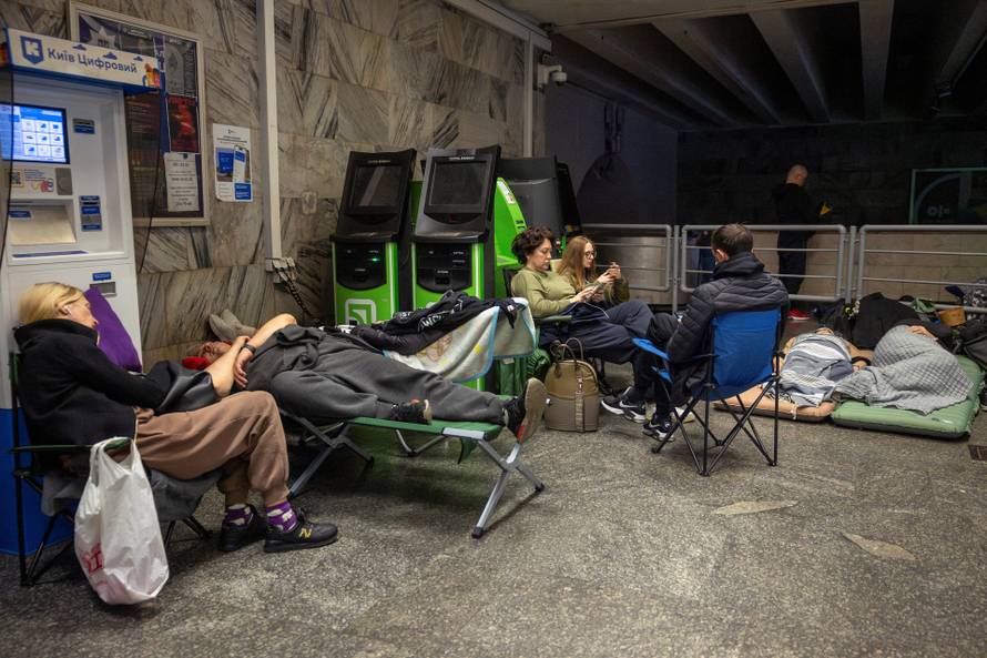 People take shelter in a metro station during a Russian drone attack in Kyiv