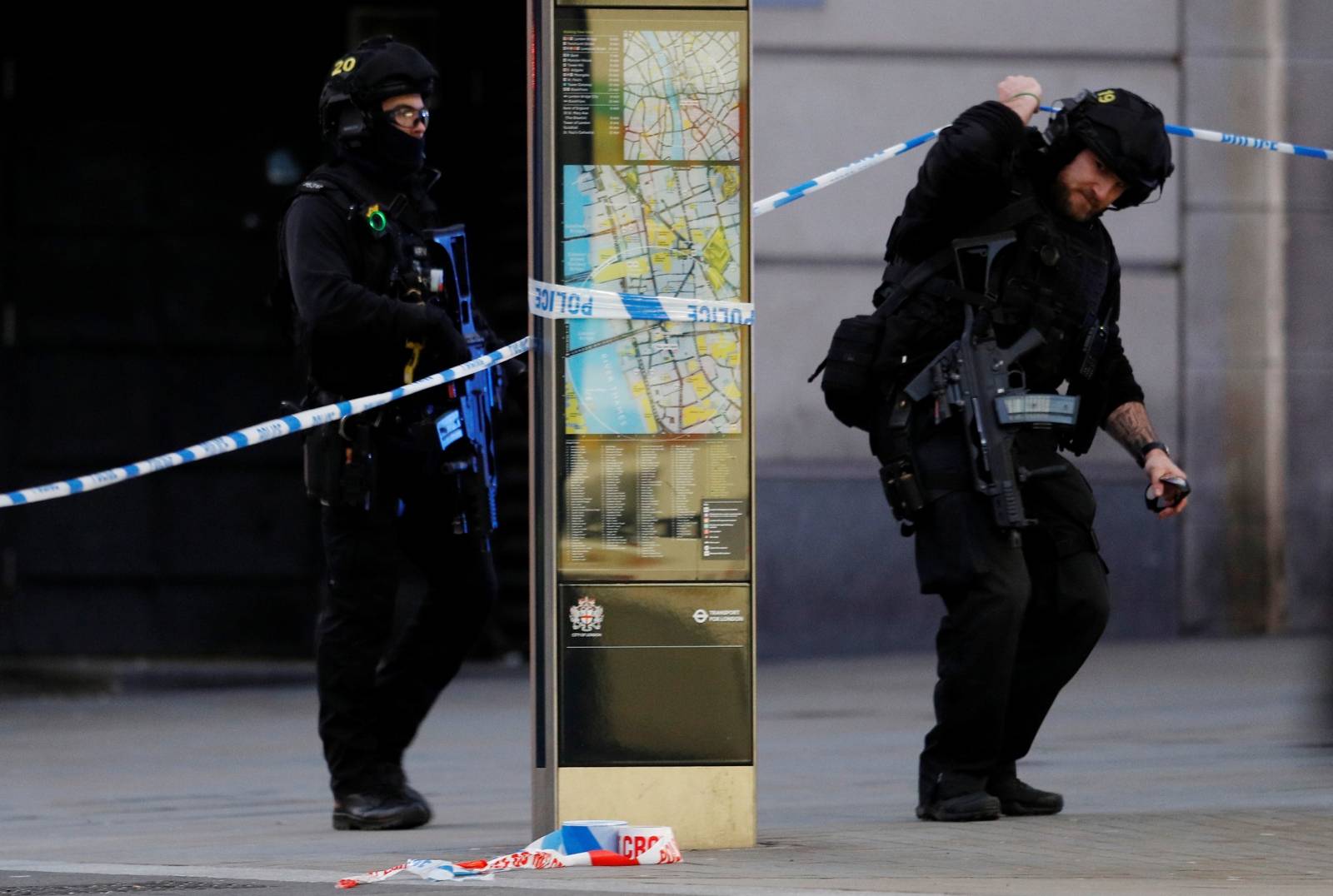 Police officers walk near the site of an incident at London Bridge in London