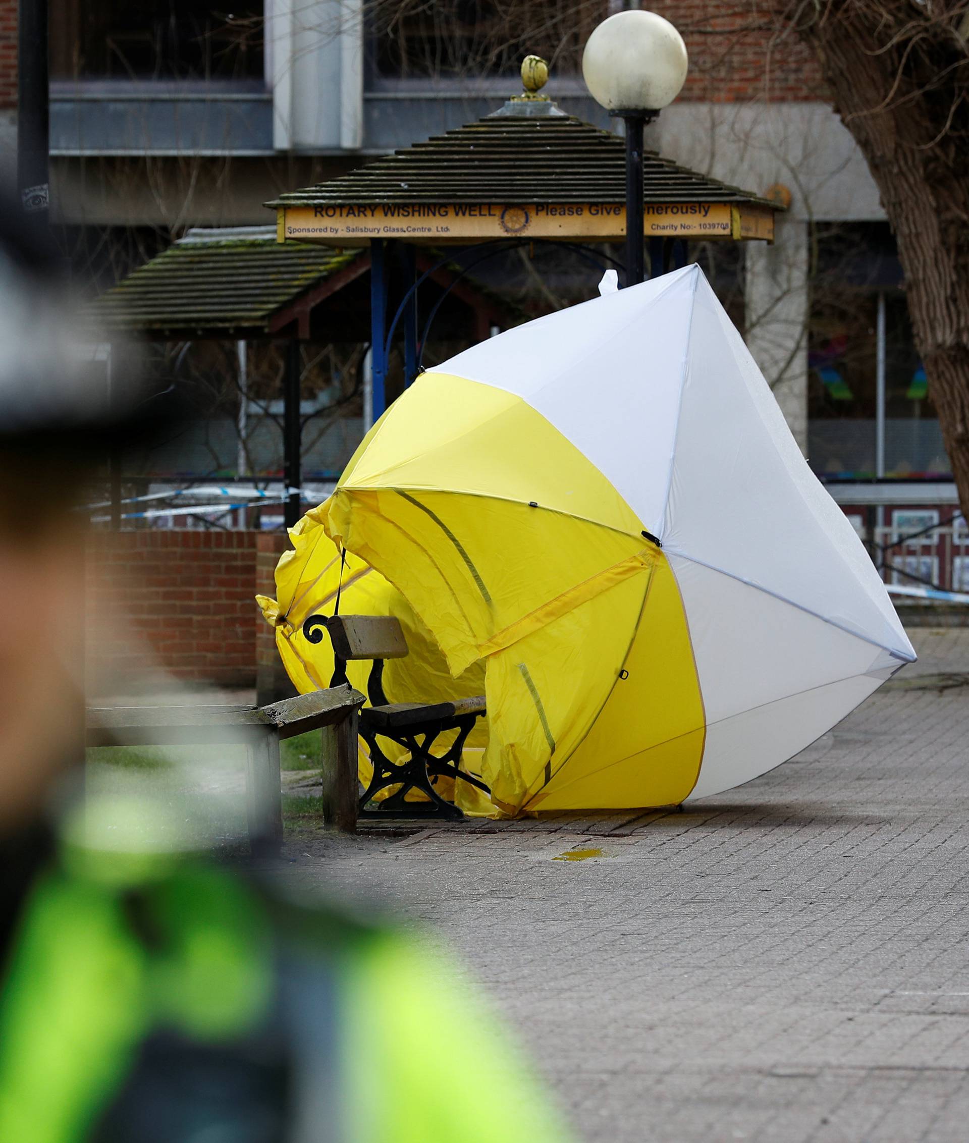 The forensic tent, covering the bench where Sergei Skripal and his daughter Yulia were found, is blown out of position in the centre of Salisbury