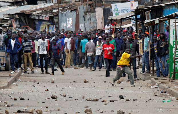 Demonstrators, supporting opposition leader Raila Odinga, throw stones in Mathare, in Nairobi