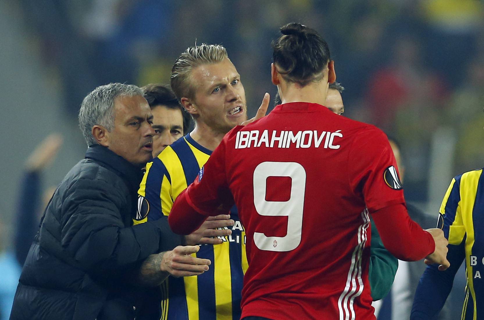 Manchester United's Zlatan Ibrahimovic clashes with Fenerbahce's Simon Kjaer as manager Jose Mourinho looks on