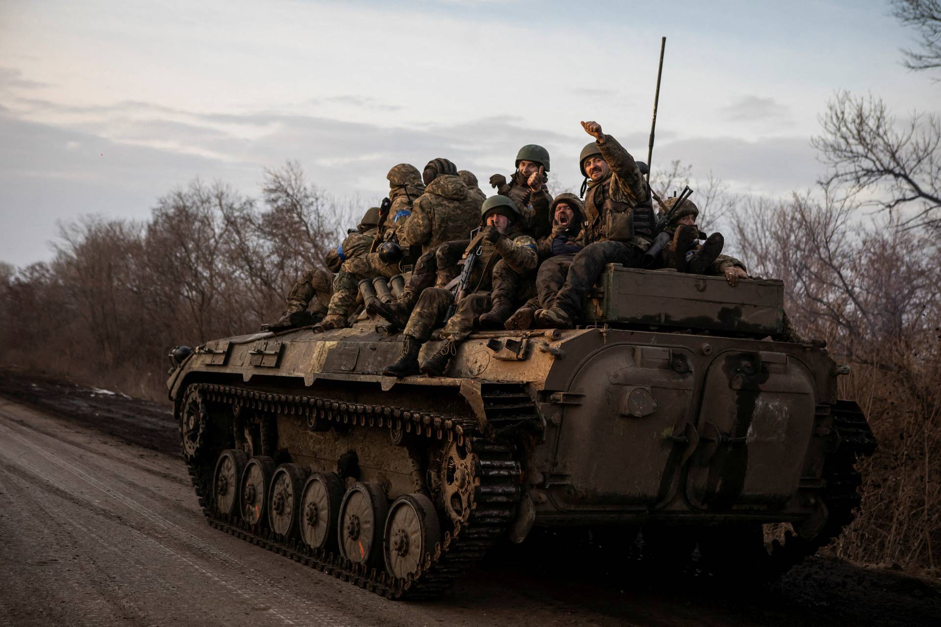 FILE PHOTO: Ukrainian servicemen sit atop a BMP-2 infantry fighting vehicle on a road outside the frontline town of Bakhmut