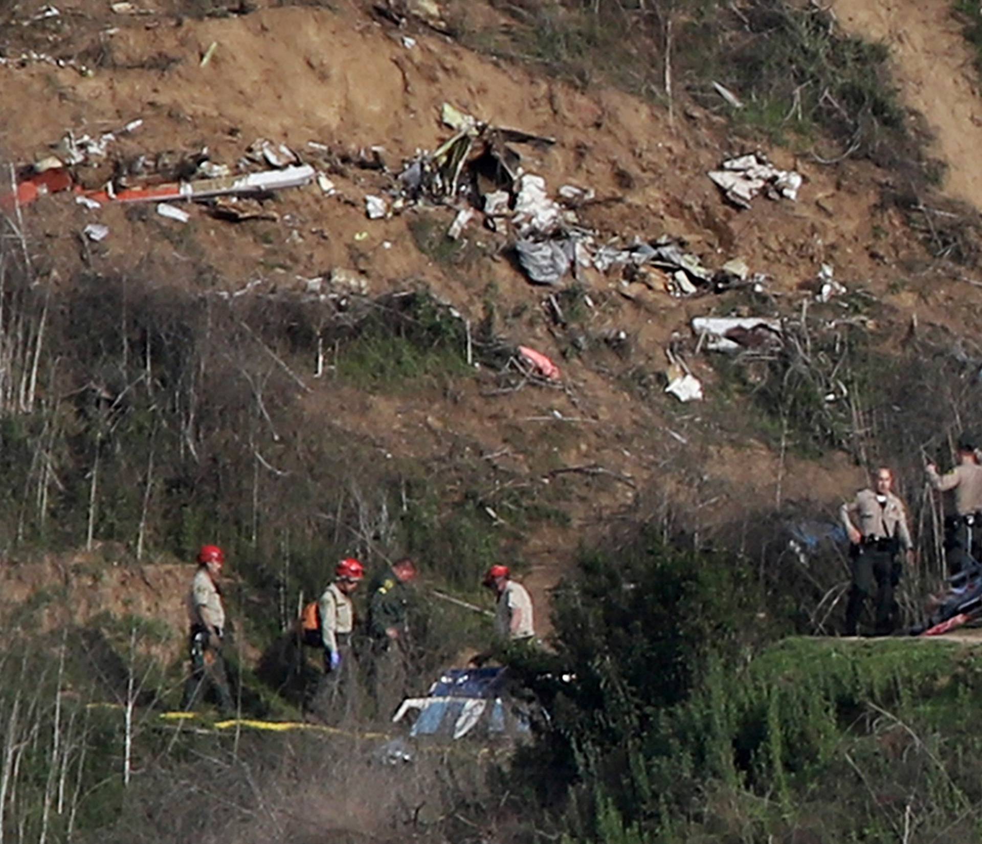 Sheriffs and officials investigate the helicopter crash site of NBA star Kobe Bryant in Calabasas, California