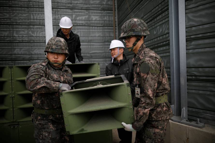 South Korean soldiers dismantle loudspeakers that were set up for propaganda broadcasts near the demilitarized zone separating the two Koreas in Paju