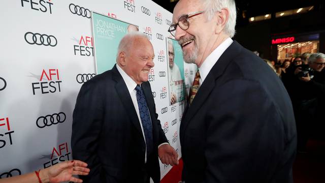 Cast members Pryce and Hopkins greet each other at a premiere for the film "The Two Popes" during AFI Fest 2019 in Los Angeles