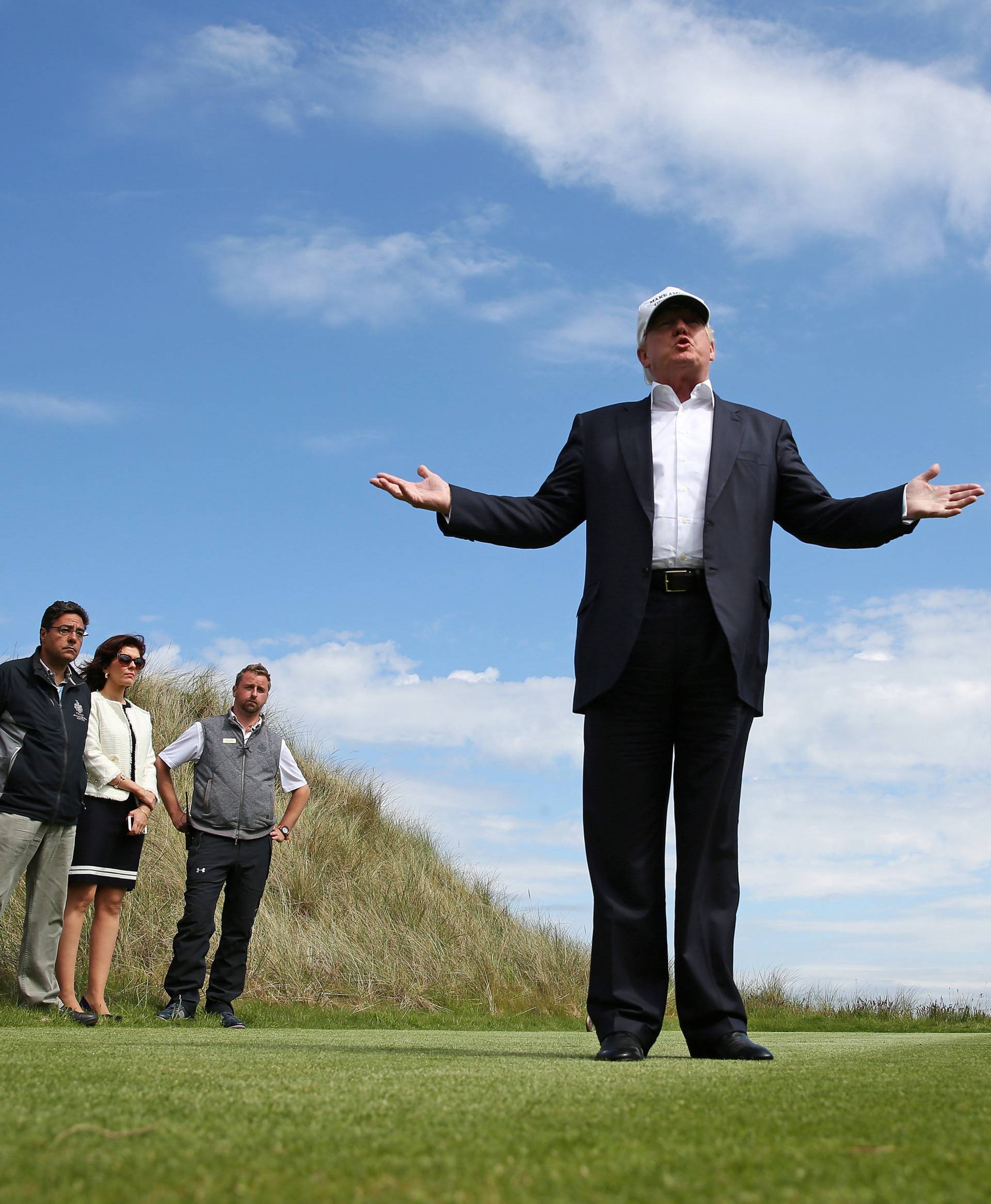 Republican presidential candidate Donald Trump speaks to the media on the golf course at his Trump International Golf Links in Aberdeen