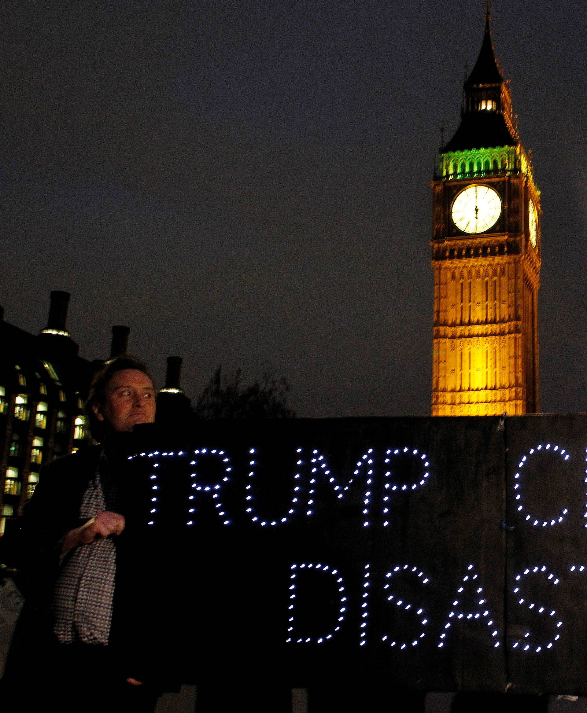 Demonstrators hold a banner during a protest against U.S. President Donald Trump in London