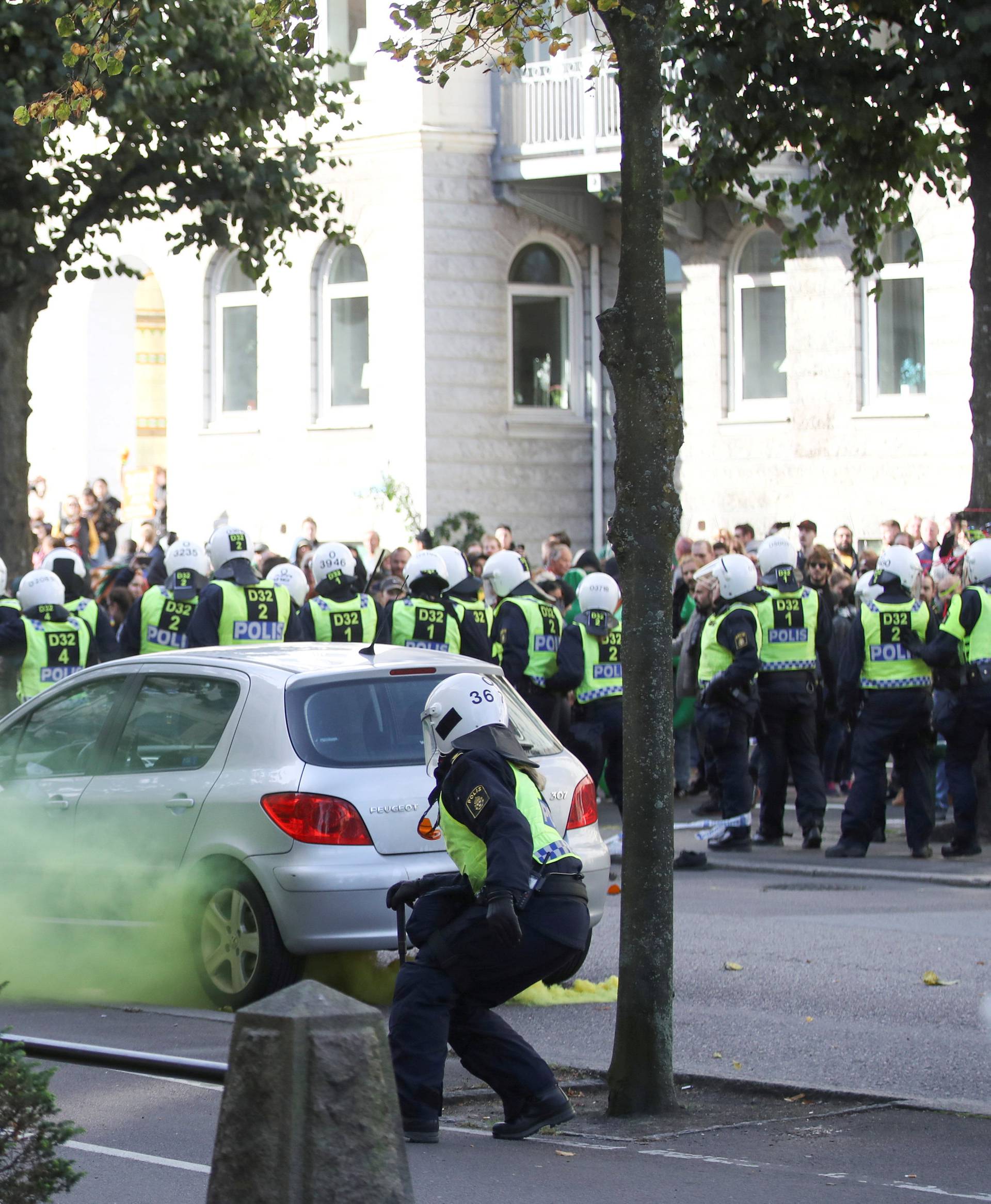 Police officers react to counter-demonstrators prior to the Nordic Resistance Movement's (NMR) march in central Gothenburg