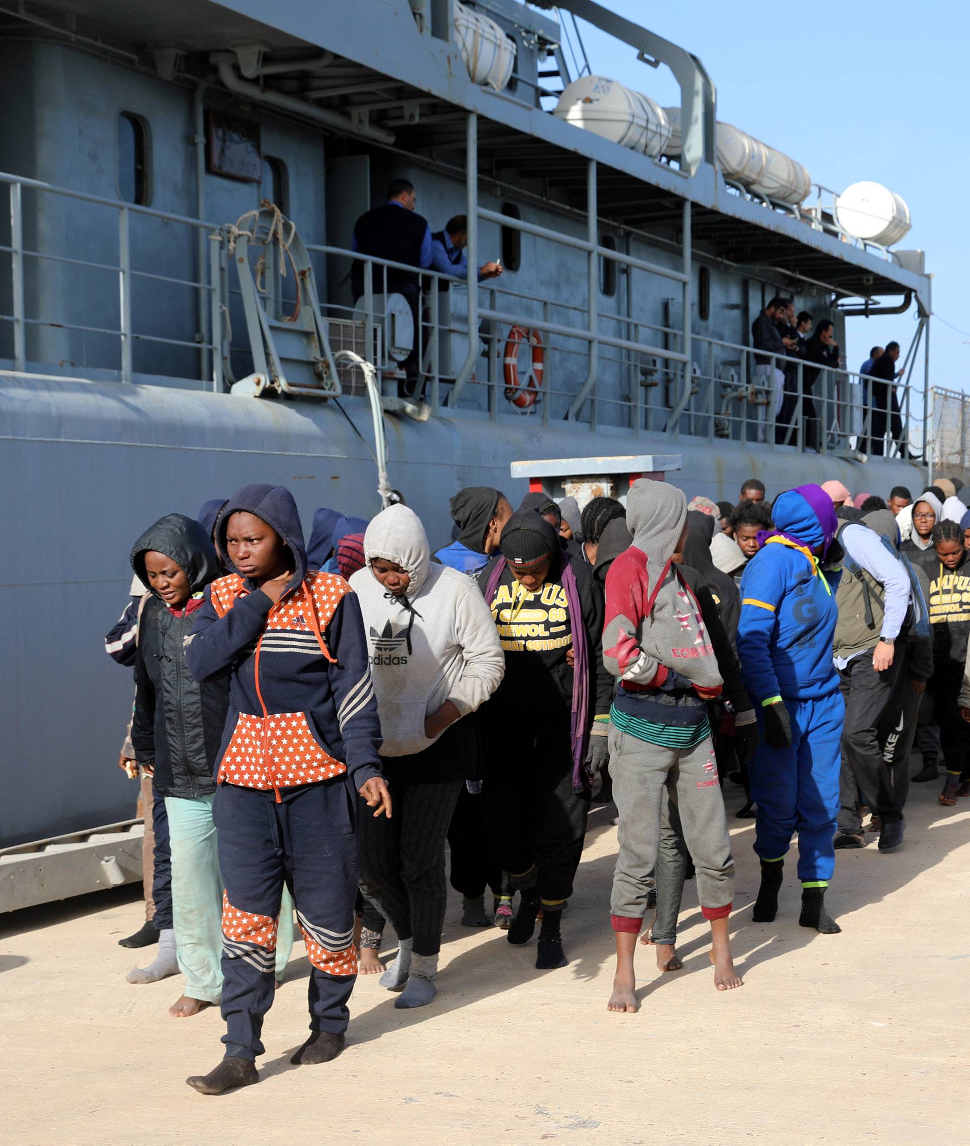 Migrants arrive at a naval base after they were rescued by Libyan coast guards, at a naval base in Tripoli