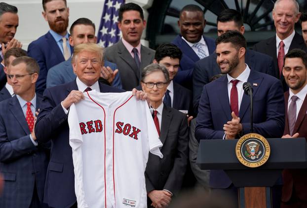 FILE PHOTO: U.S. President Donald Trump holds a Boston Red Sox jersey presented by outfielder and designated hitter J.D. Martinez while welcoming the 2018 World Series Champions on the South Lawn at the White House in Washington.