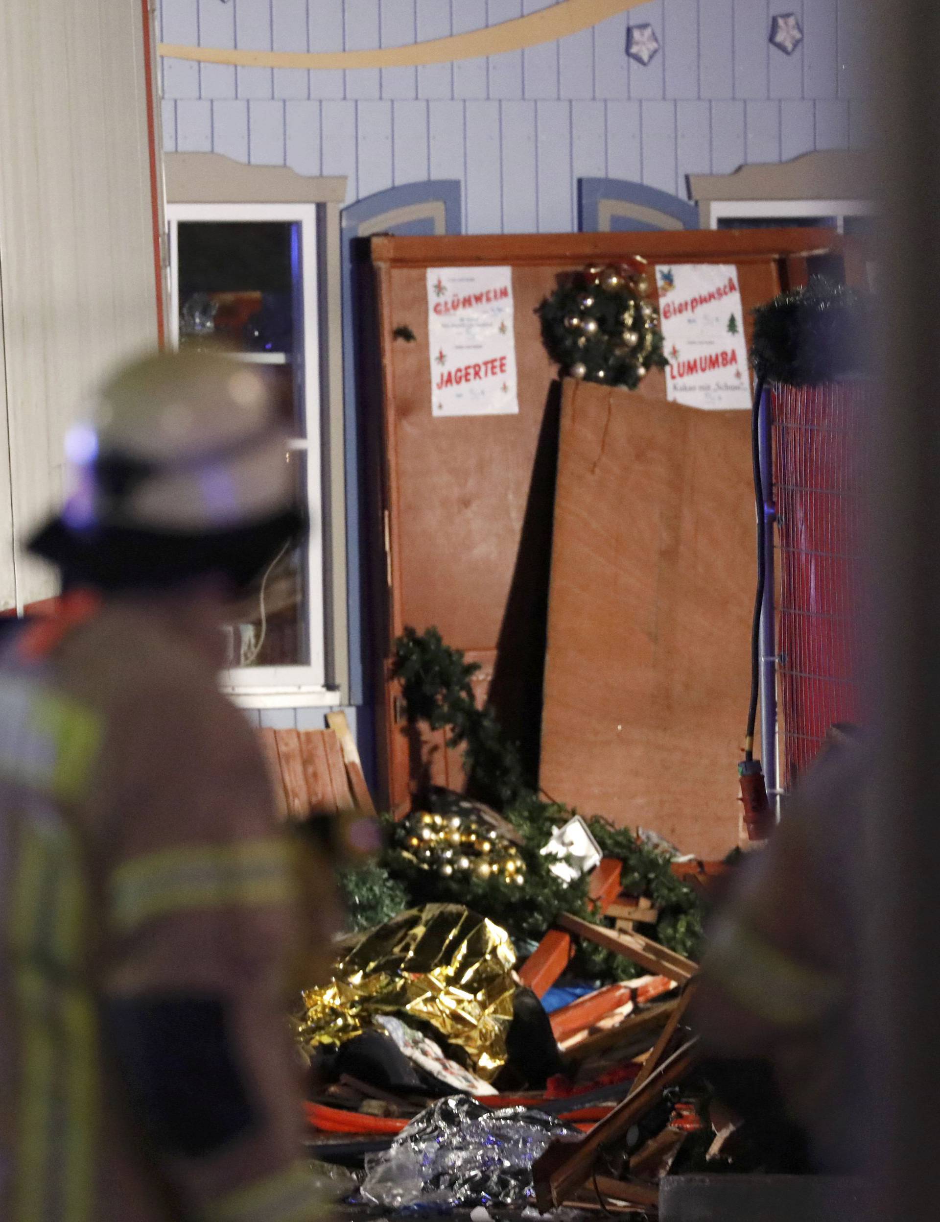 A firefighter looks at rescue blankets at a Christmas market in Berlin