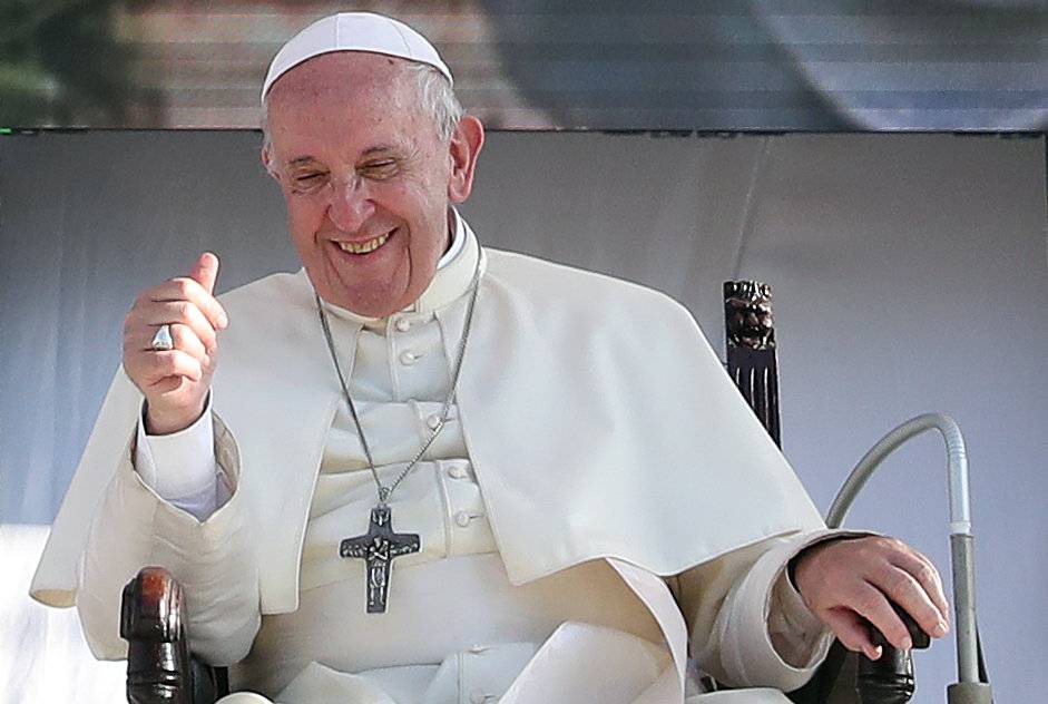 Pope Francis reacts as he meets with young people at the Politeama square in Palermo