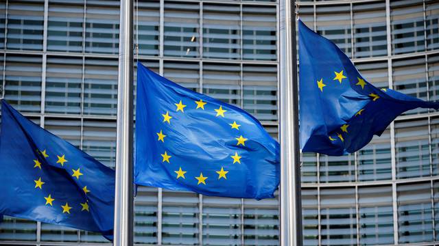 FILE PHOTO: European Union flags fly outside the European Commission headquarters in Brussels