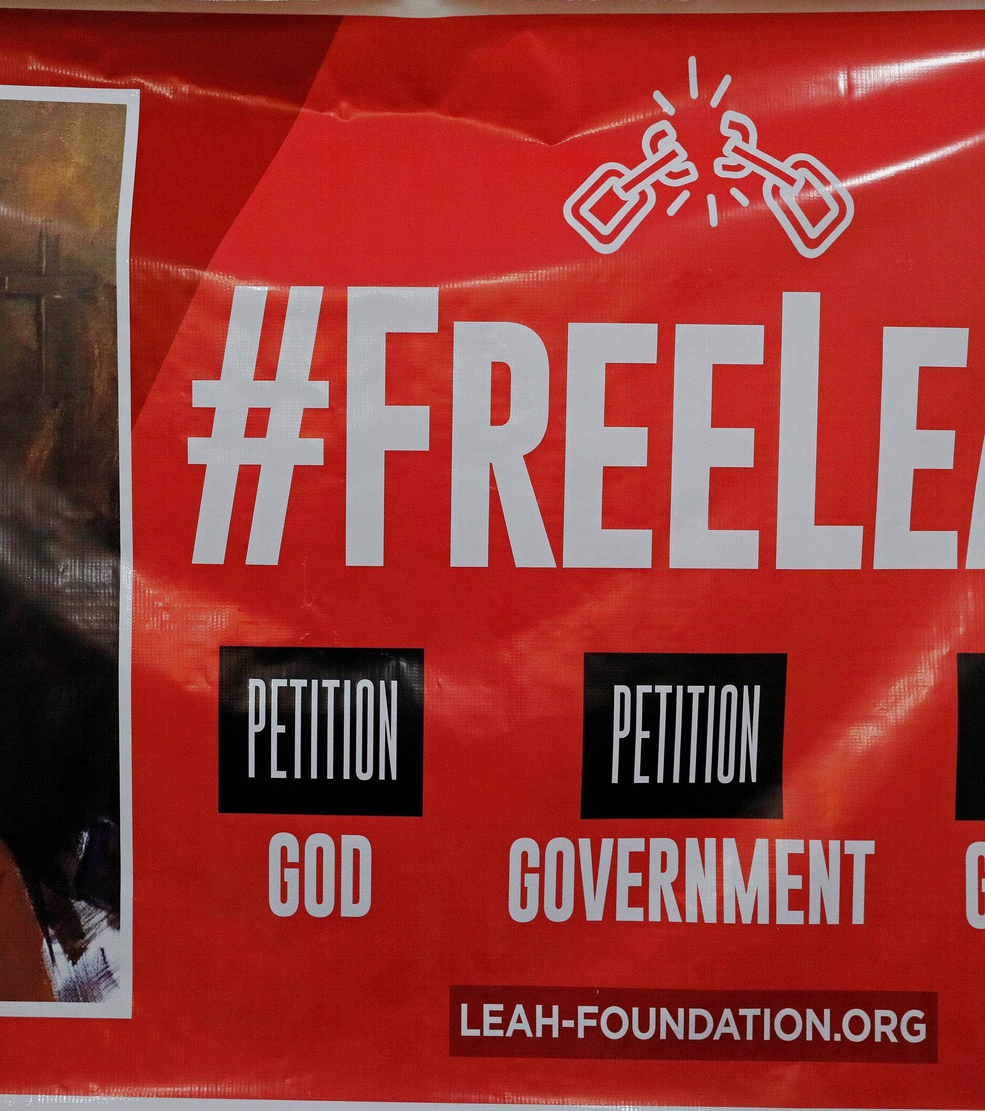 The image of Leah is seen on a banner during a news conference at the Pope John Paul center in Abuja
