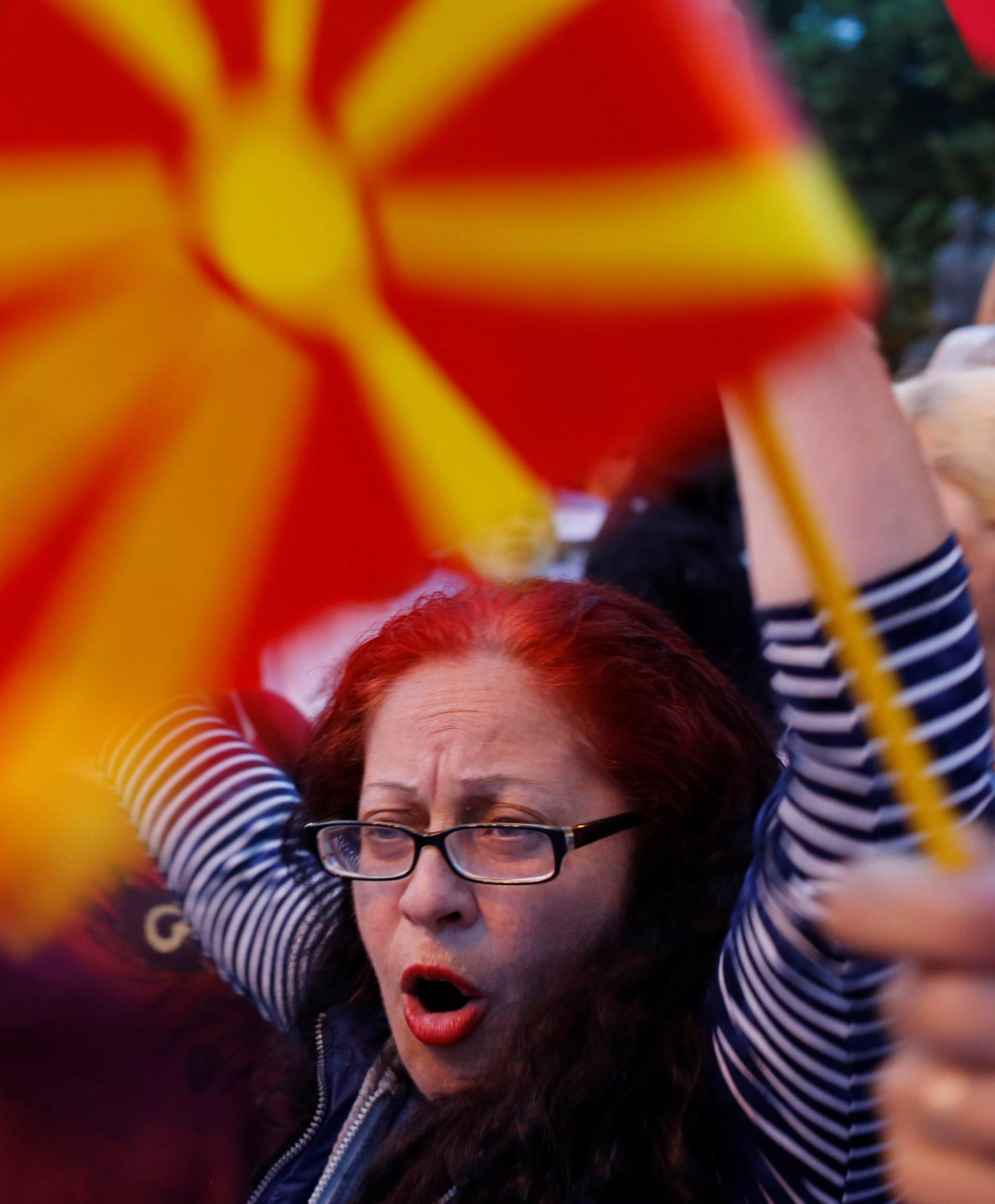 Protestors shout slogans against the change of the country's constitutional name in front of the Parliament building in Skopje