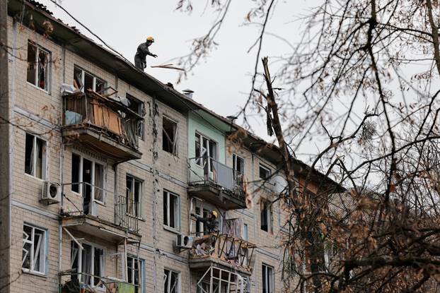 Emergency responders work at the site of a Russian drone strike on an apartment building, in Kyiv
