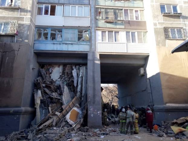 Emergency personnel are seen at the site of collapsed apartment building after a suspected gas blast in Magnitogorsk