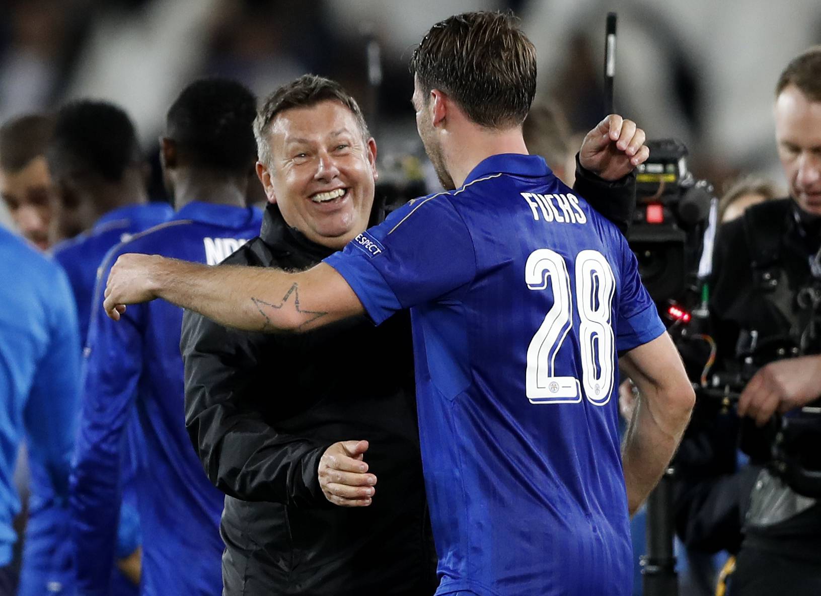 Leicester City manager Craig Shakespeare celebrates with Christian Fuchs after the game