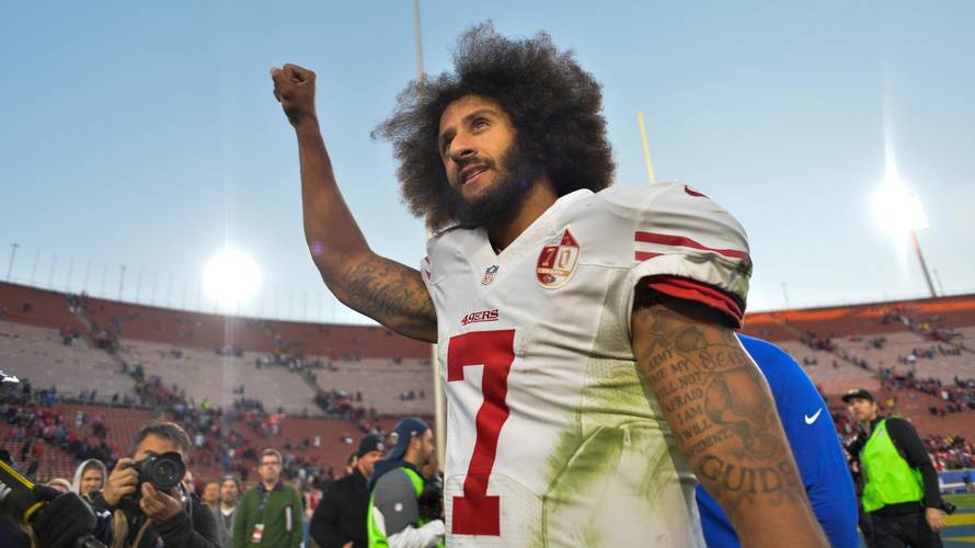 FILE PHOTO - Colin Kaepernick pumps his fist as he acknowledges the cheers at Los Angeles Memorial Coliseum in Los Angeles