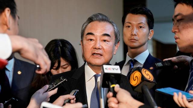 FILE PHOTO: Chinese Foreign Minister Wang Yi meets Japanese Prime Minister Shinzo Abe