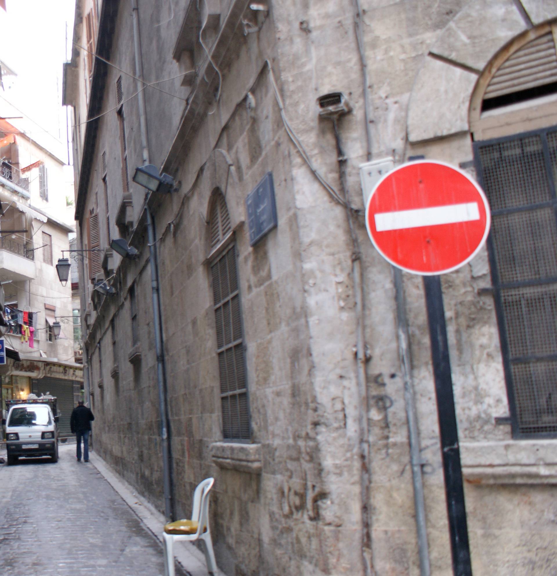 A man walks past shops in al-Jdeideh neighbourhood, in the Old City of Aleppo