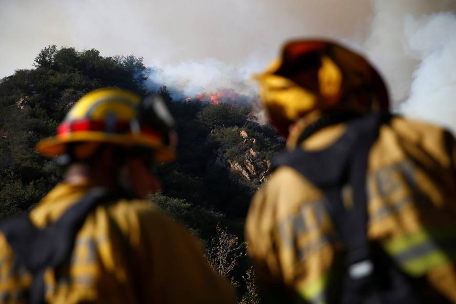 Firefighters battle the Woolsey Fire as it continues to burn in Malibu, California,