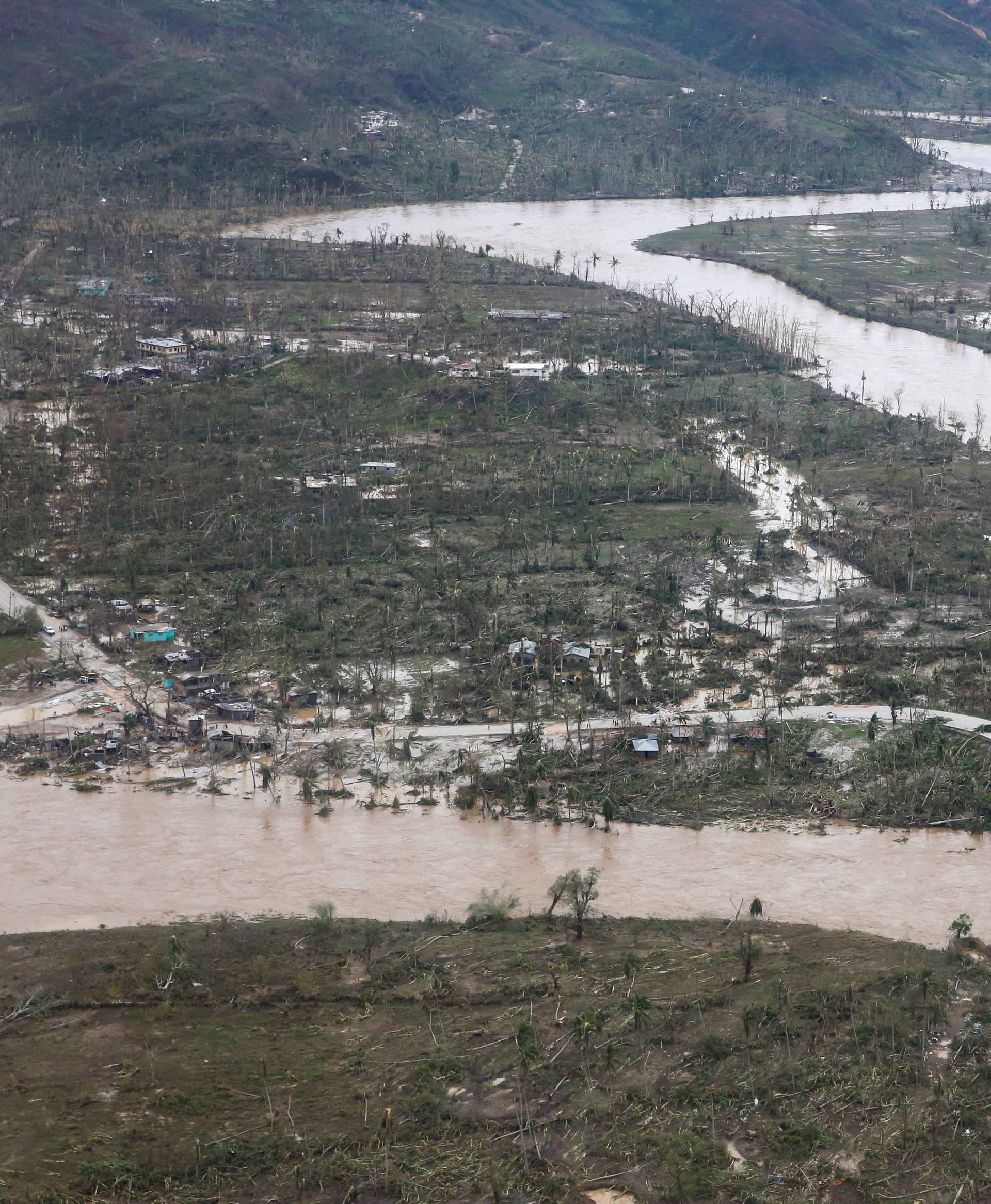 A flooded river and destroyed houses are seen after Hurricane Matthew passes Jeremie, Haiti