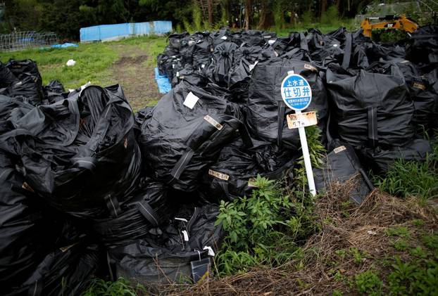 FILE PHOTO: Waste containing irradiated soil, leaves and debris from the decontamination operation are collected in Naraha town, Fukushima prefecture