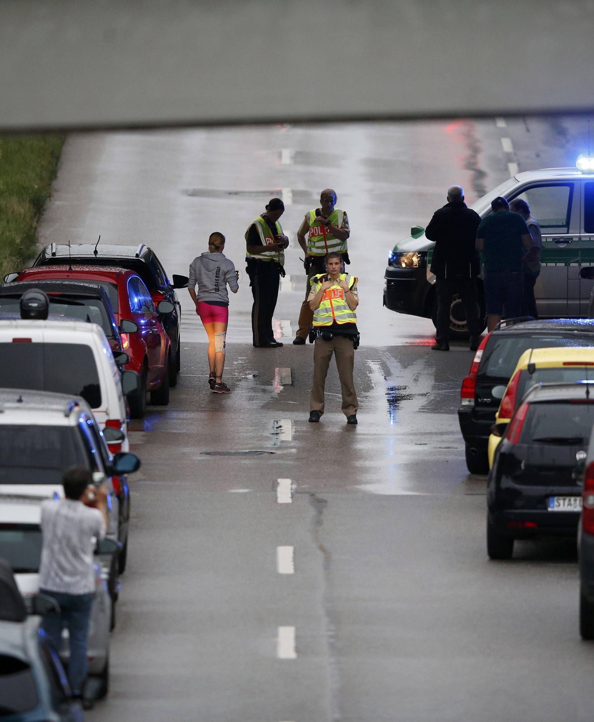 Police halt traffic on road near to scene of a shooting rampage in Munich