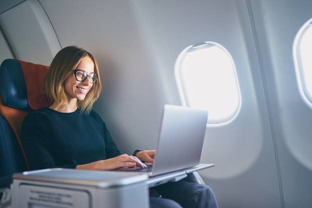 Traveling,And,Technology.,Flying,At,First,Class.,Pretty,Young,Businees