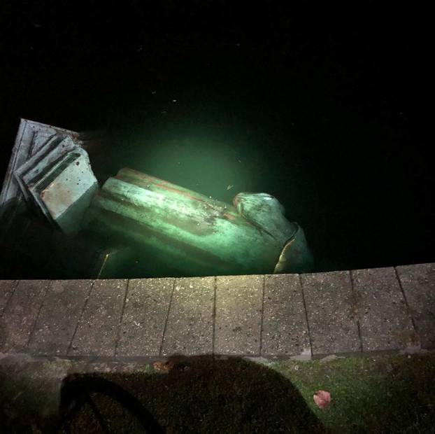 The statue of Christopher Columbus is seen in a lake after it was pulled down by protesters in Richmond