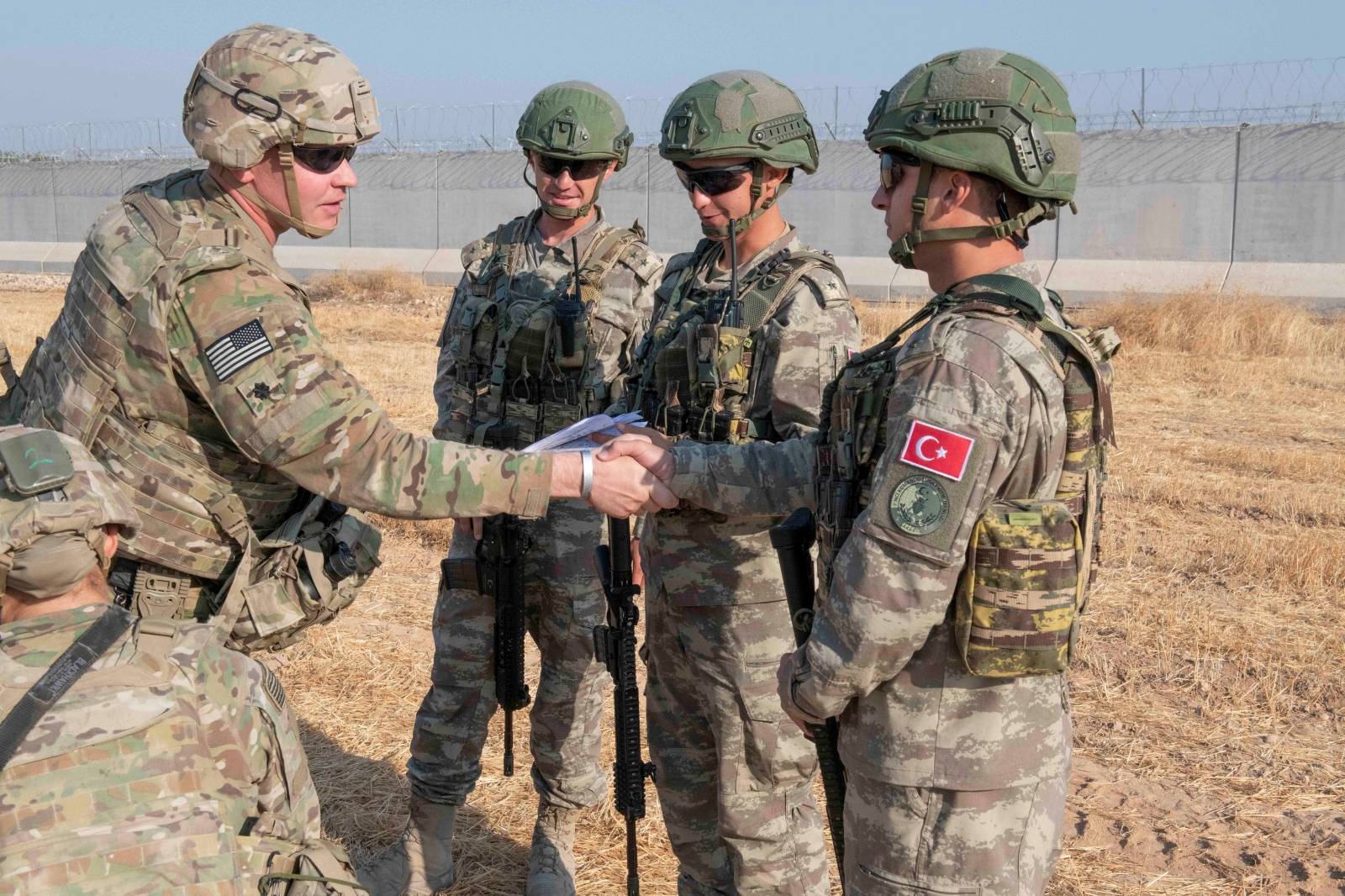 U.S. and Turkish military forces conduct a joint ground patrol in northeast Syria