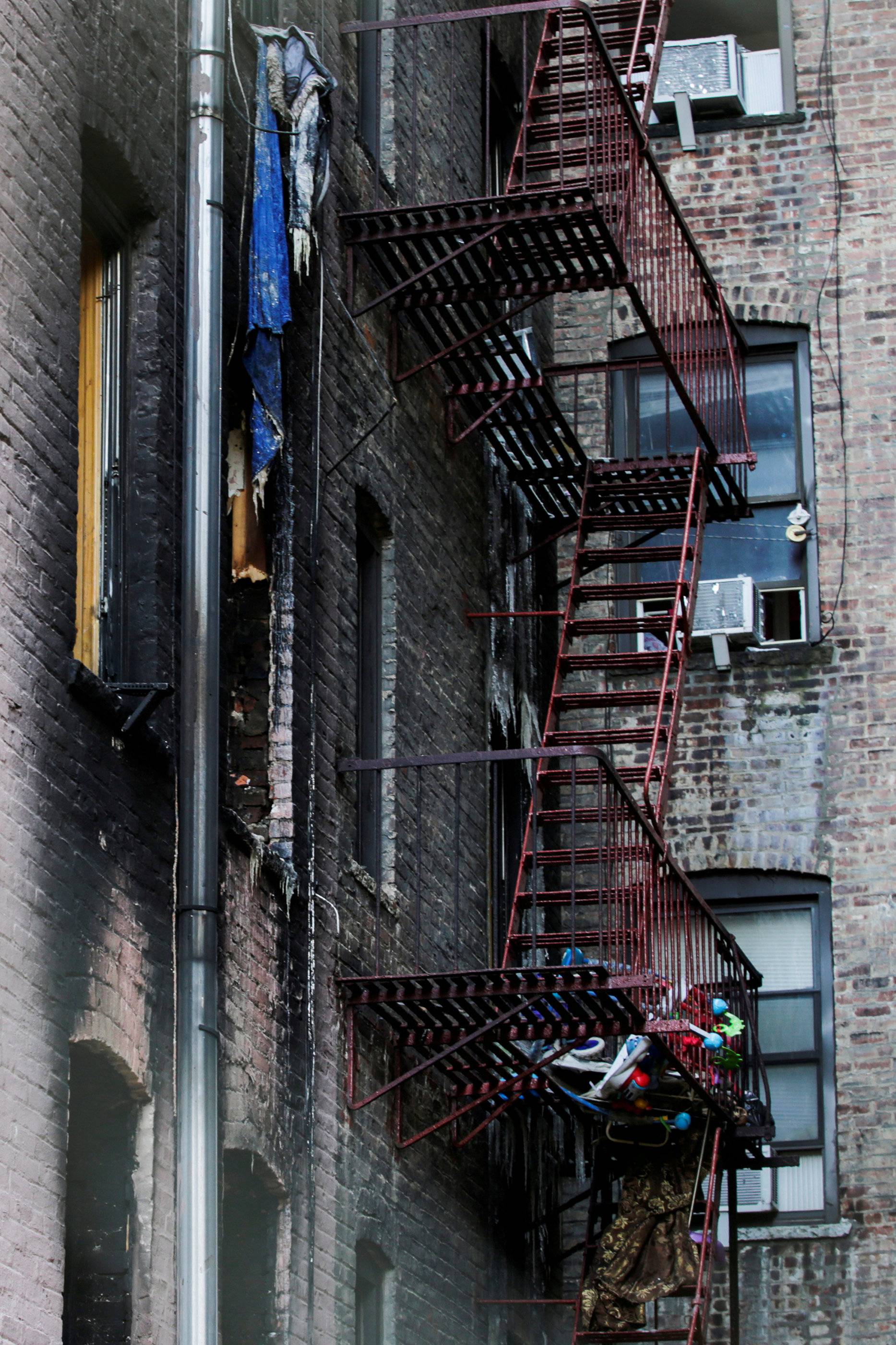 Windows of burned apartments are seen after a fire in a building in Bronx, New York