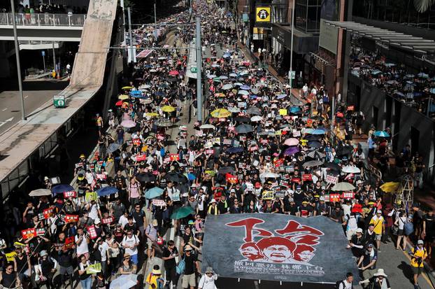 Anti-extradition bill protesters march during the anniversary of Hong Kong