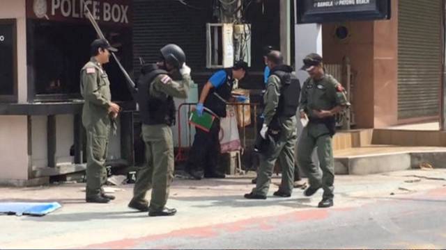 Officials investigate at the scene of bomb blasts in the tourist beach town of Patong on Phuket island