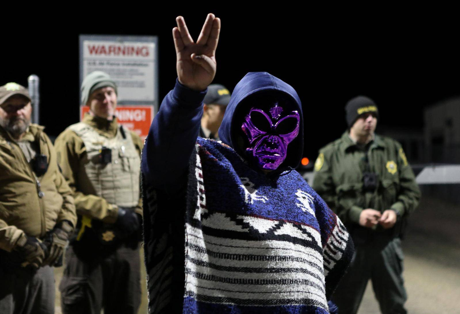 An attendee wears an alien mask at the gate of Area 51 as an influx of tourists responding to a call to 'storm' Area 51, a secretive U.S. military base believed by UFO enthusiasts to hold government secrets about extra-terrestrials, is expected in Rachel