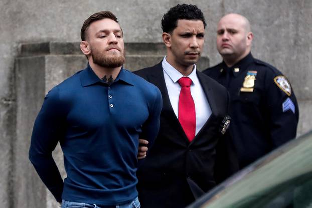 FILE PHOTO: MMA fighter McGregor walks out of the 78th police precinct after charges were laid against him in the Brooklyn borough of New York City