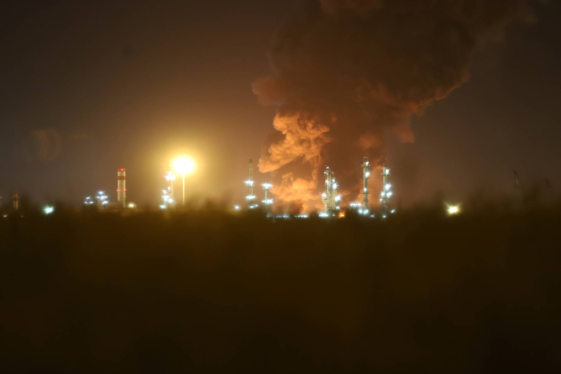 Smoke rises at an oil refinery in Tehran