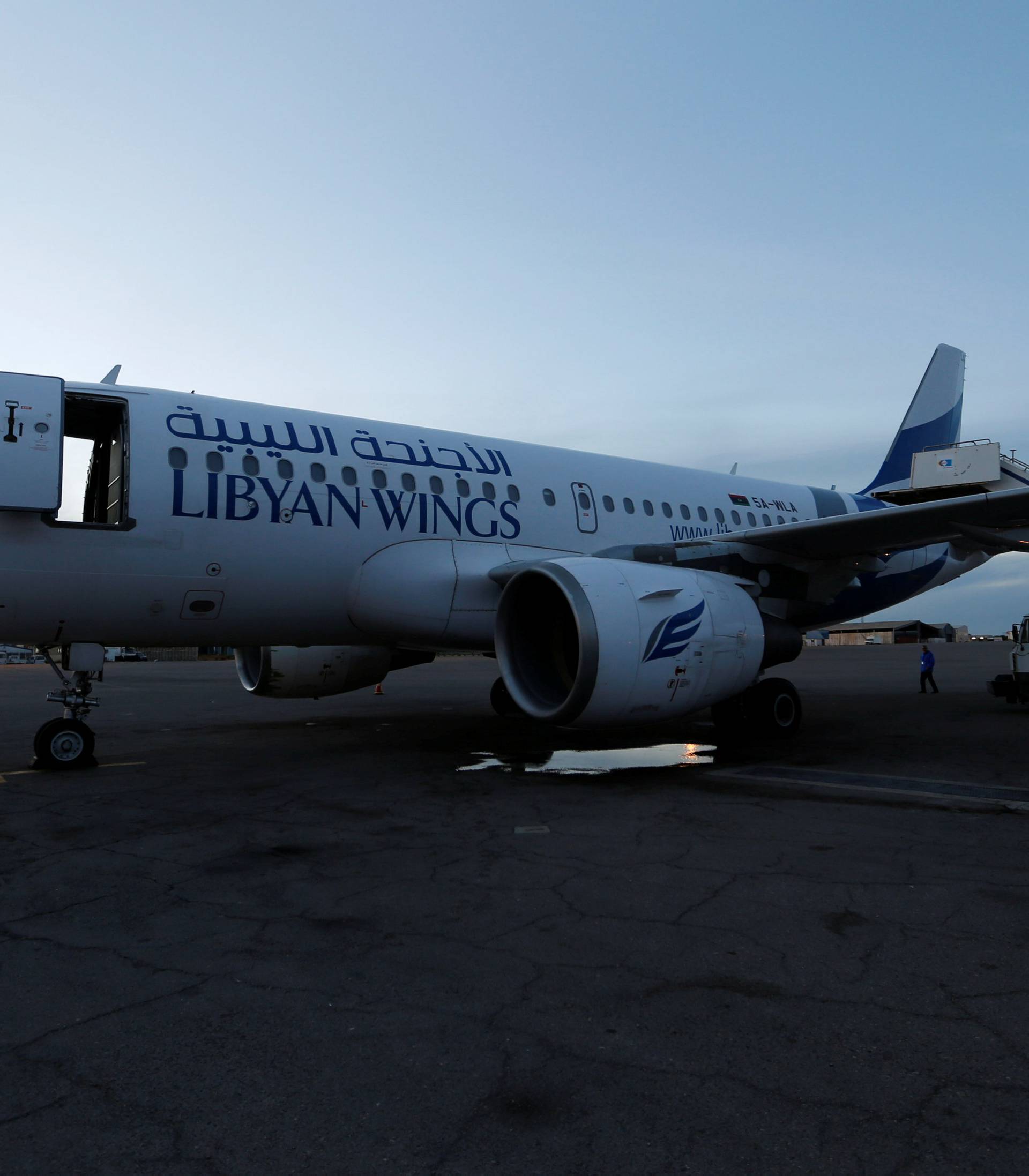 Plane, that was damaged during clashes, is seen at Mitiga airport in Tripoli