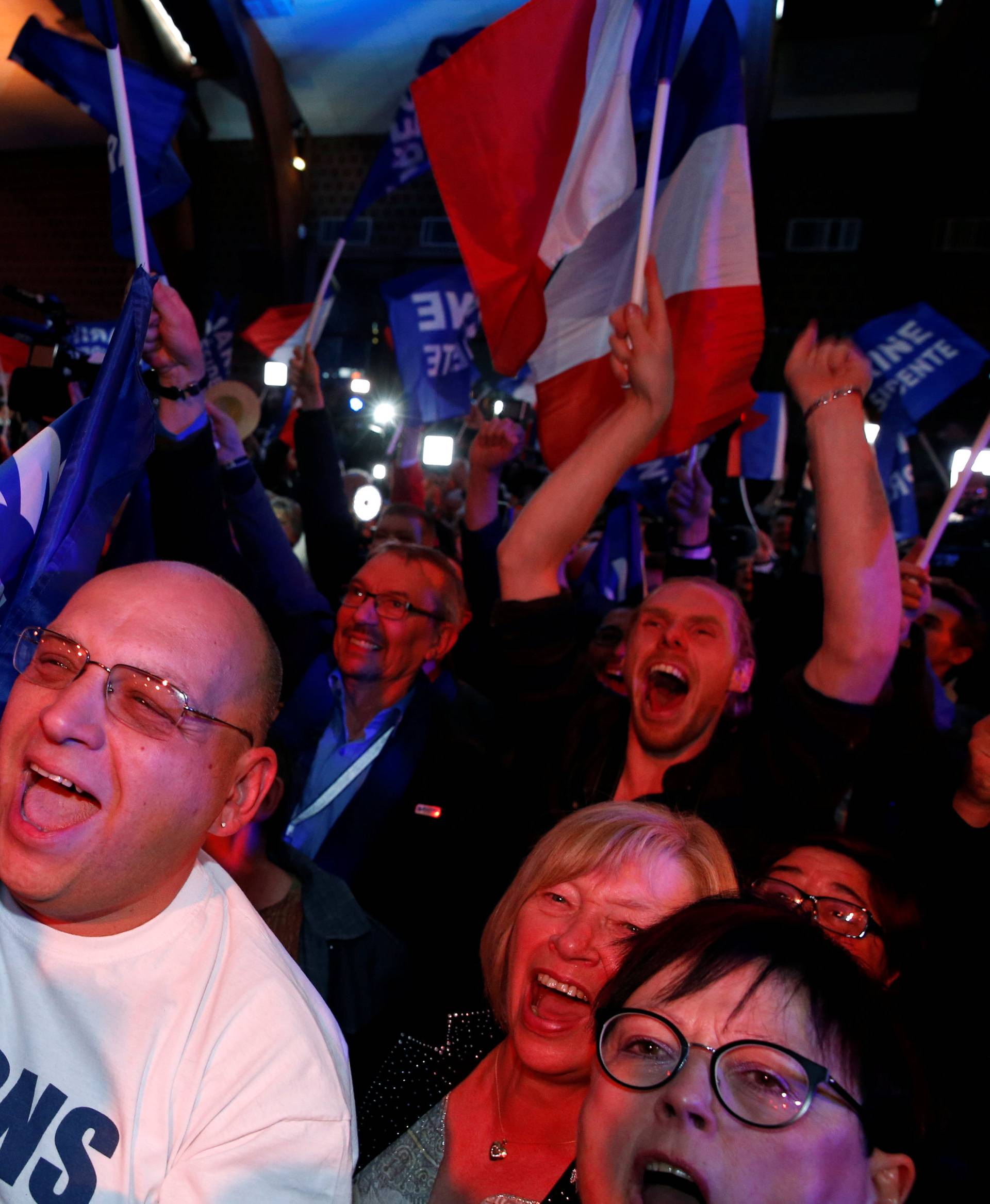 Supporters of Marine Le Pen, French National Front (FN) political party leader and candidate for French 2017 presidential election, react after early results in the first round of 2017 French presidential election, in Henin-Beaumont