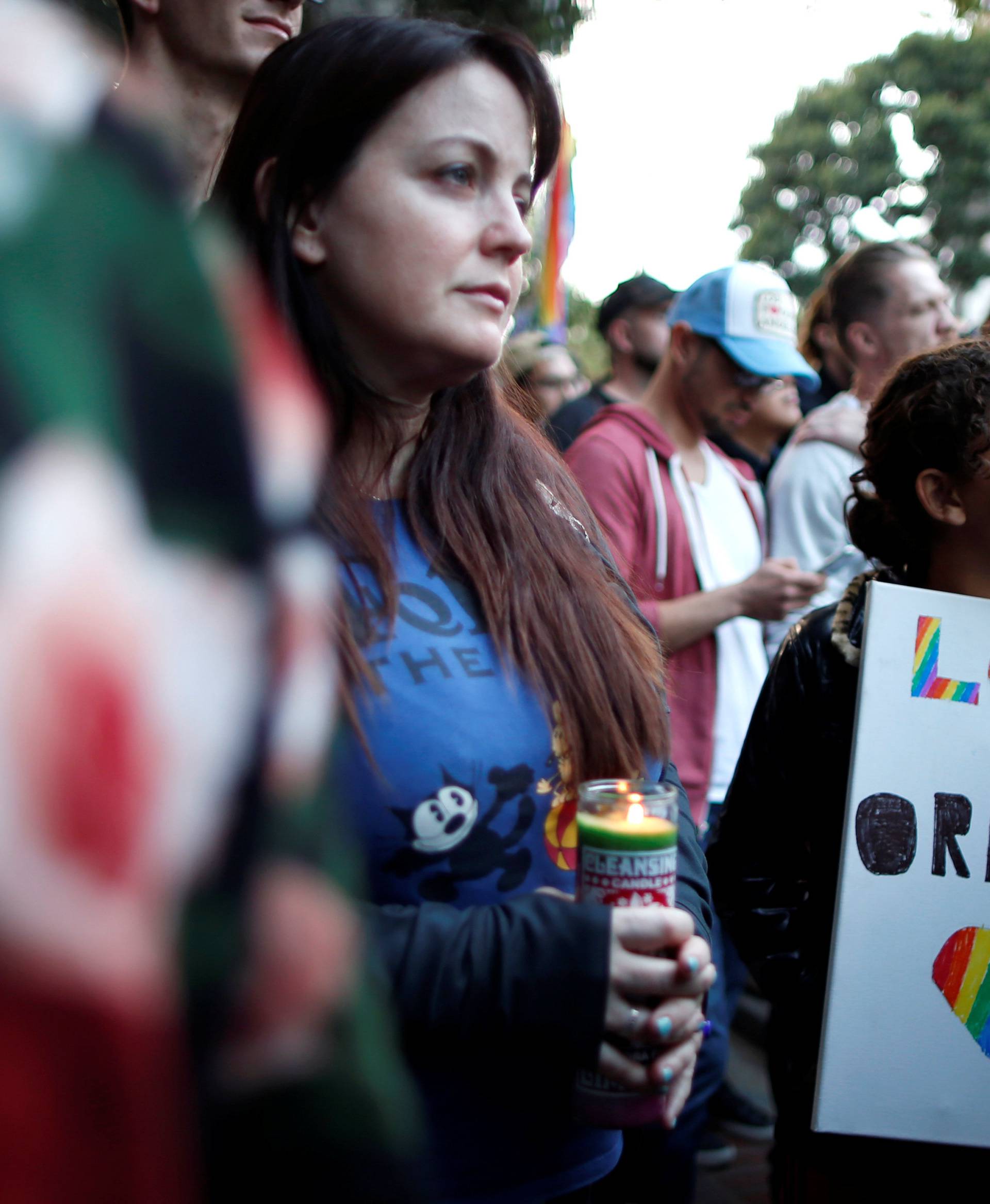 People attend a vigil in memory of victims one day after a mass shooting at the Pulse gay night club in Orlando, in Los Angeles