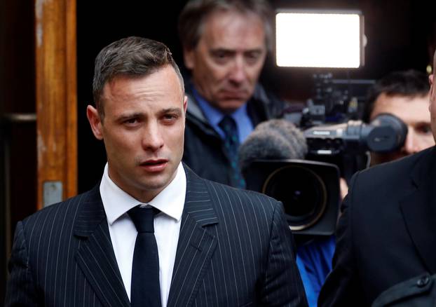 Former Paralympian Oscar Pistorius leaves during a court break at the Pretoria High Court