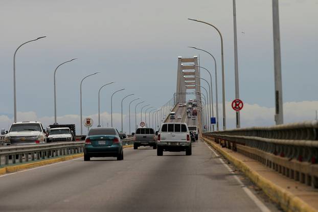 Cars drive along General Rafael Urdaneta Bridge, designed by Riccardo Morandi, in Maracaibo