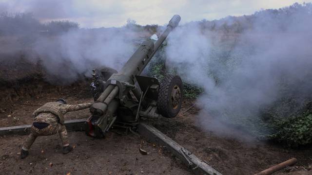Member of the Ukrainian National Guard fires a D-30 howitzer towards Russian troops in Kharkiv region