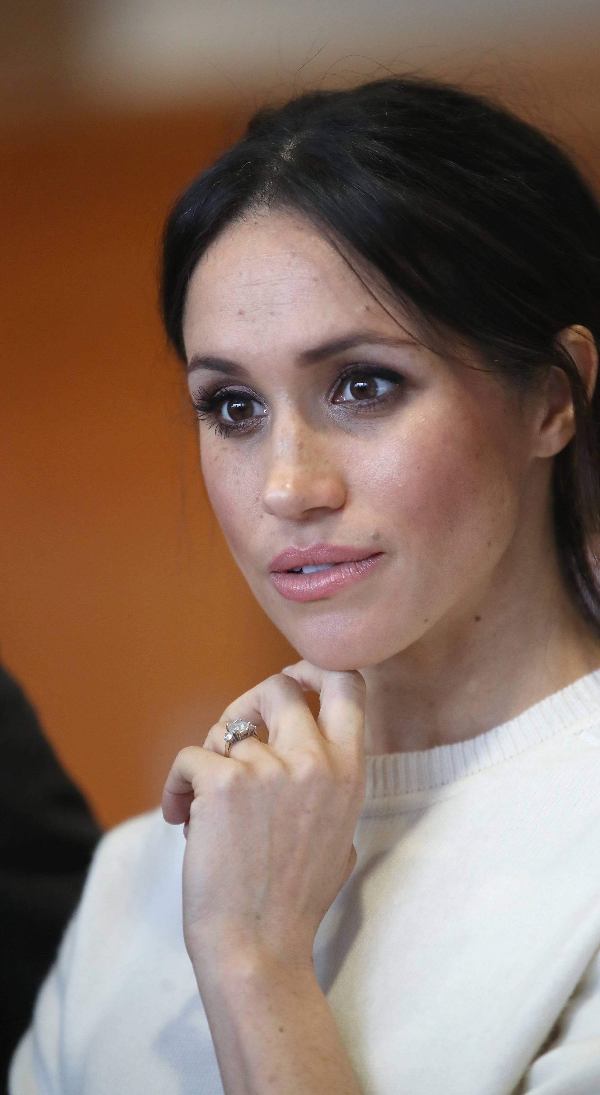 The fiancee of Britain's Prince Harry, Meghan Markle, reacts during a visit to a science park called Catalyst Inc., in Belfast