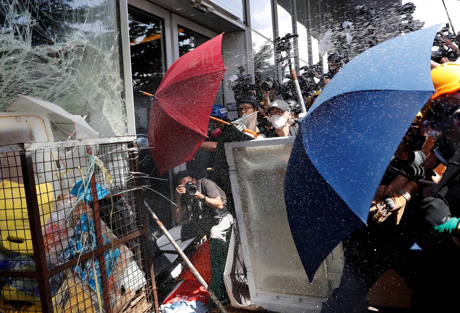 Riot police use pepper spray as protesters try to break into the Legislative Council building during the anniversary of Hong Kong's handover to China in Hong Kong