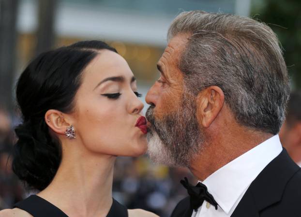 Actor Mel Gibson and partner Rosalind Ross pose on the red carpet as they arrive at the closing ceremony of the 69th Cannes Film Festival in Cannes