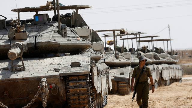 Israeli tanks park near the Israel-Gaza border in Israel